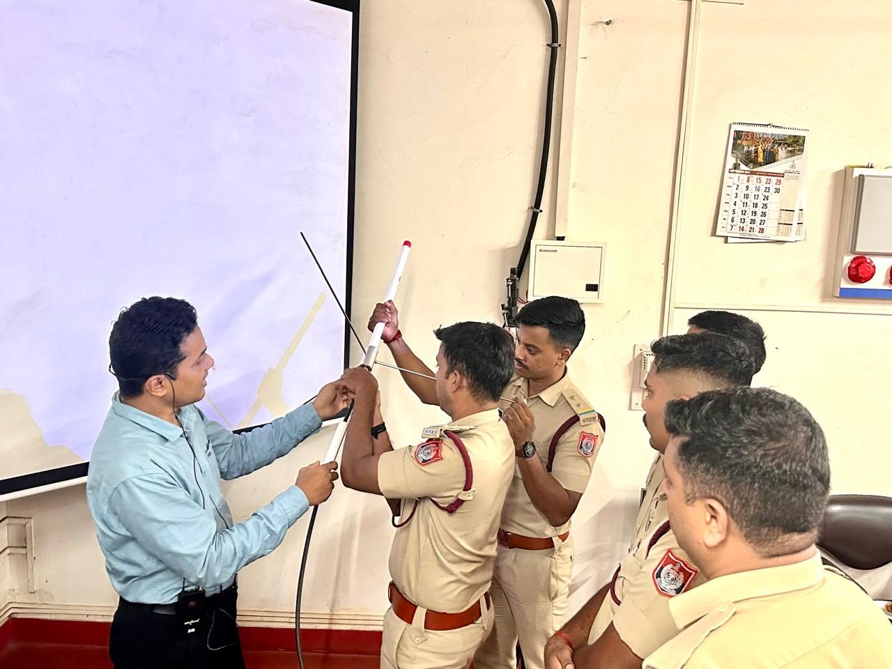 Officials practicing antenna setup during hands-on wireless training in Goa